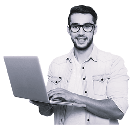 Smiling man with glasses holding a laptop